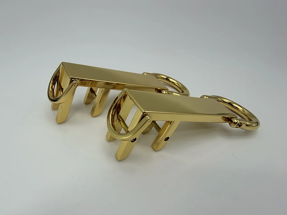 Pair of gold handle attachment fittings