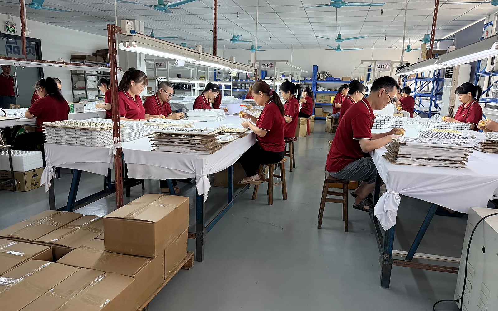 Zhenglin team working with metal hardware on the Dongguan factory floor