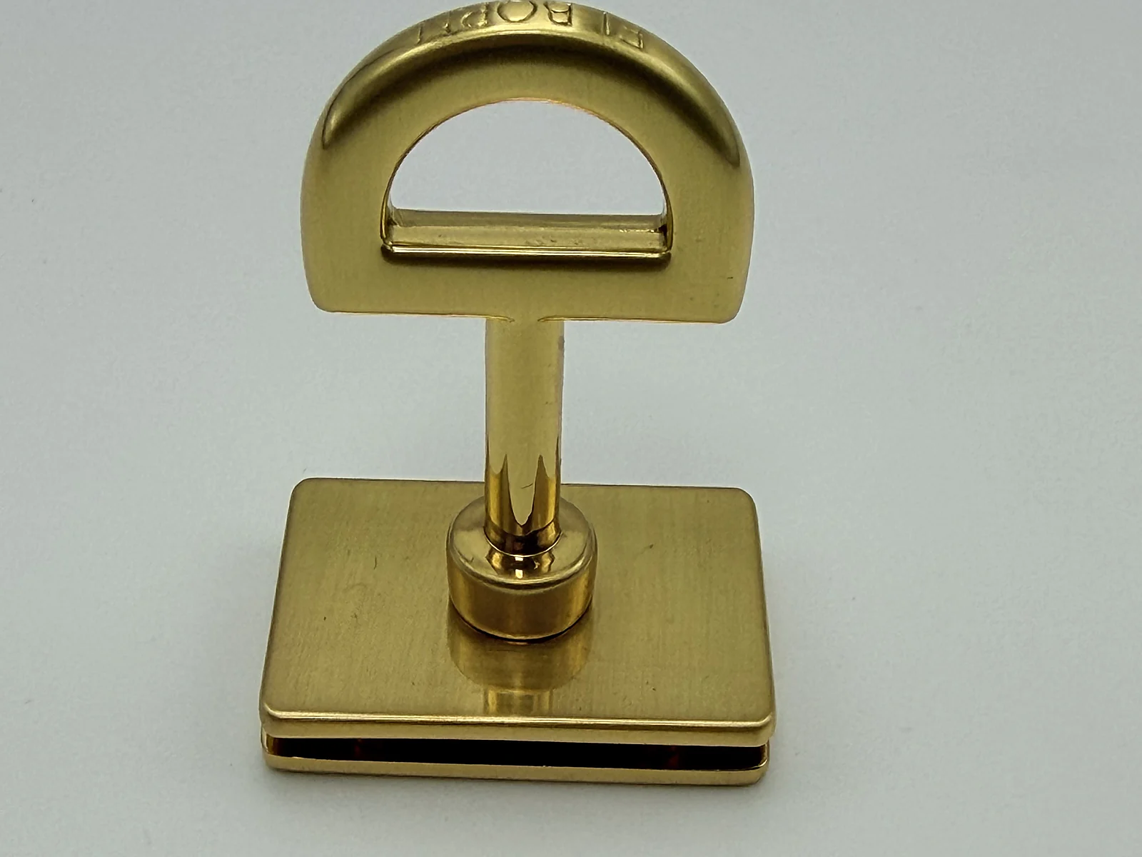 Gold-tone rectangular handbag lock sample