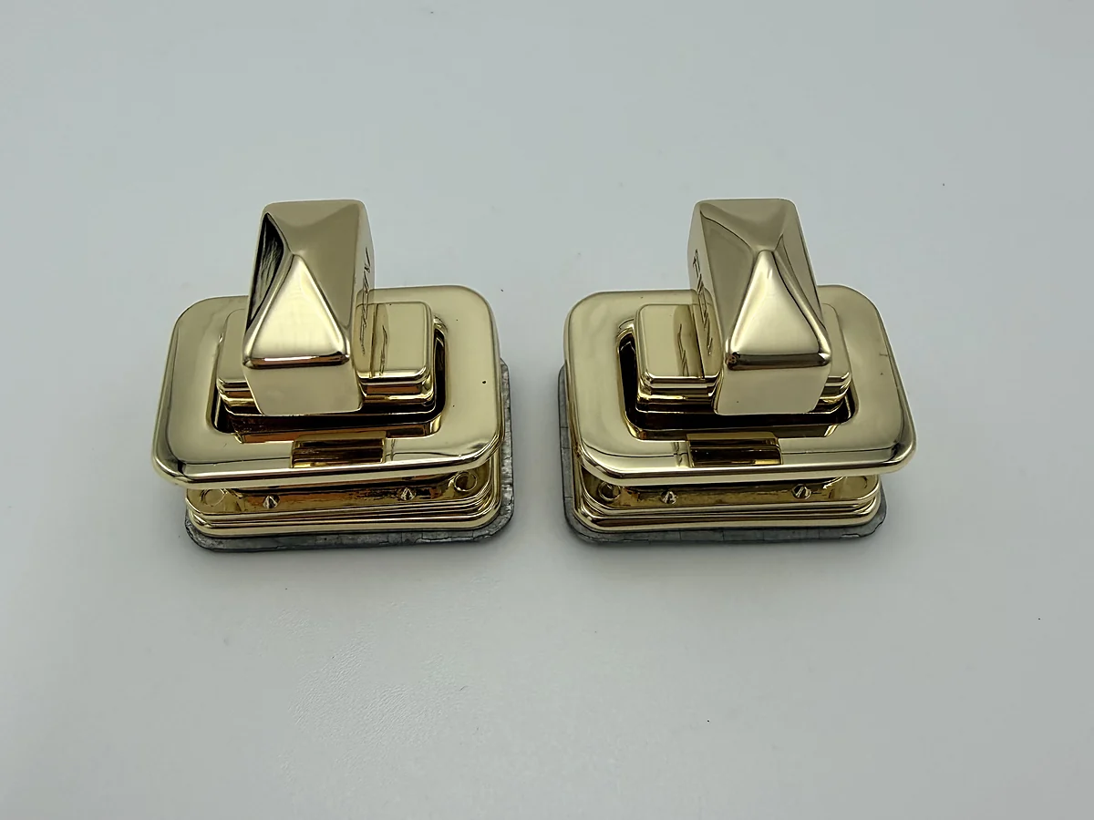 Pair of compact gold pyramid-shaped twist locks